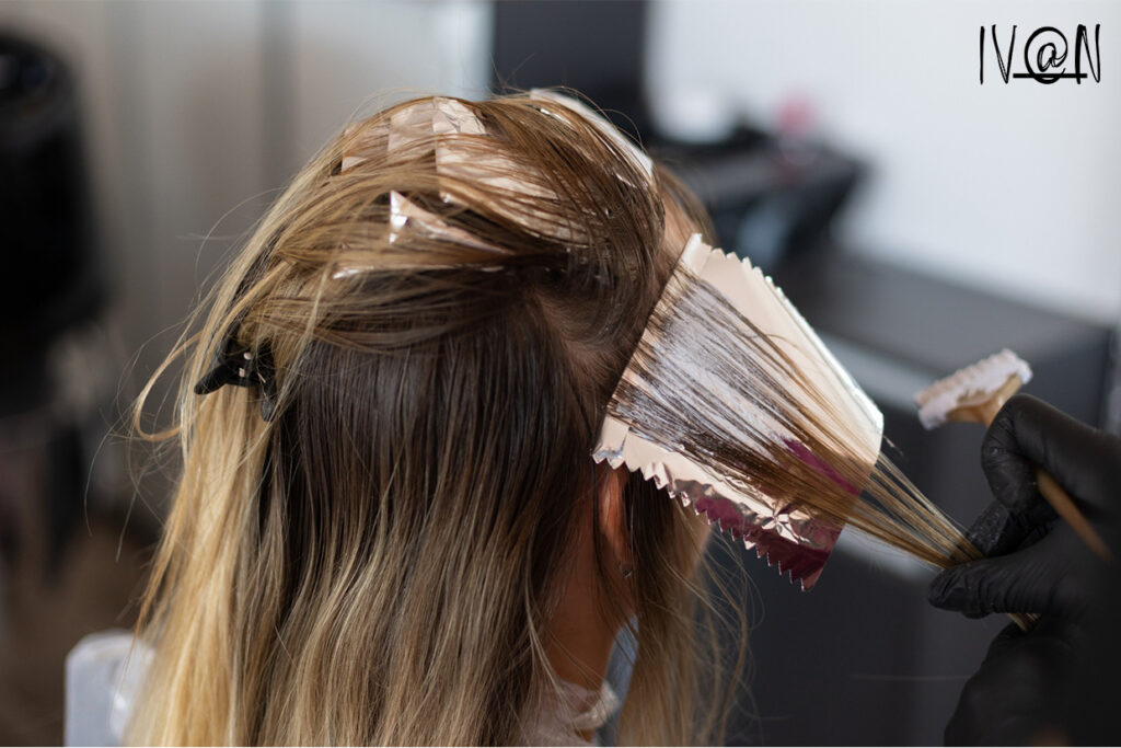 Hair specialist providing color-treated hair care to a woman