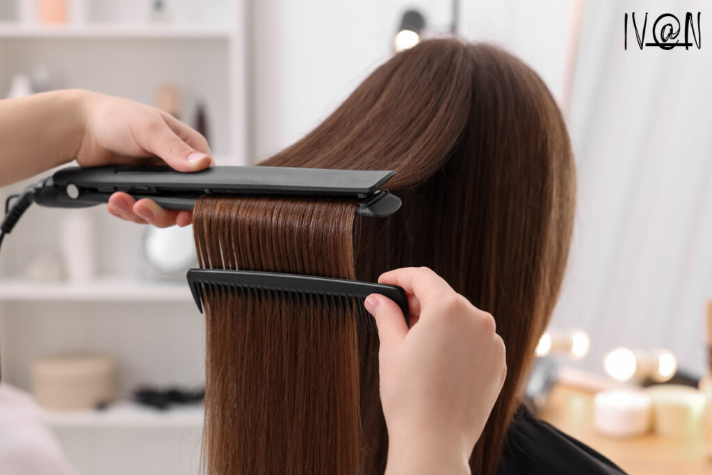 Hairstylist performing hair rebonding treatment on a woman