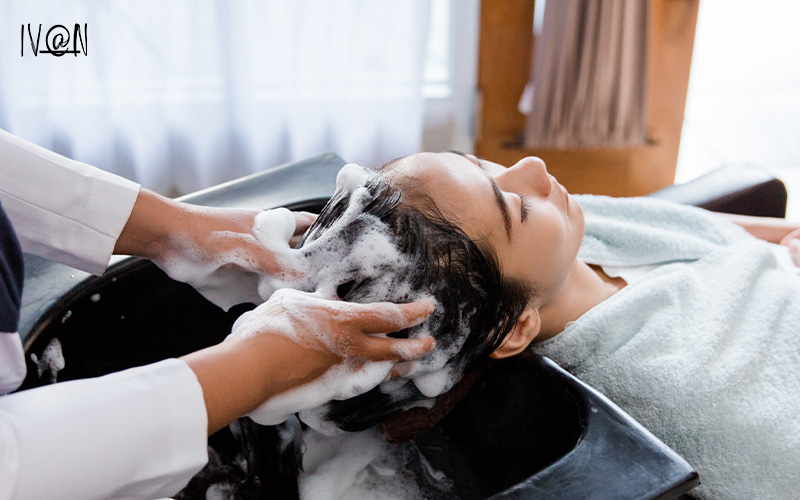 a hair stylist washing a clients hair